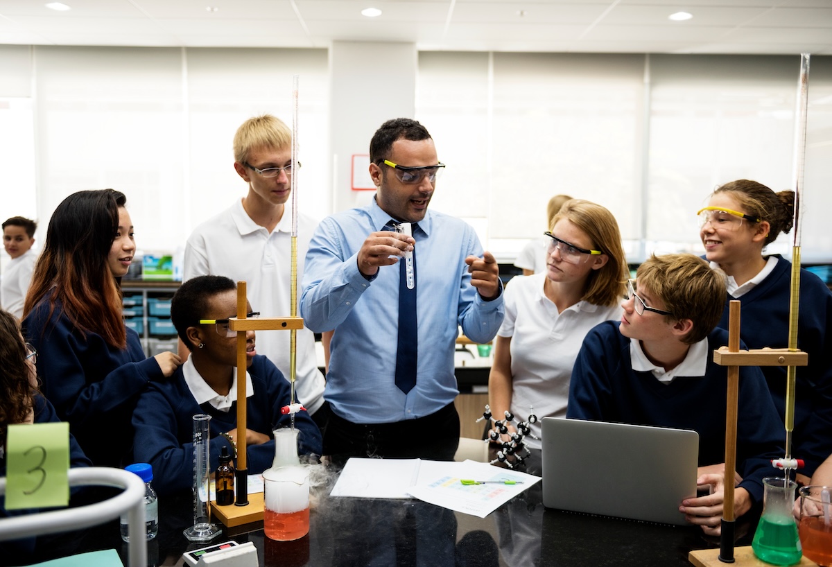 A science teacher guiding students through an investigation